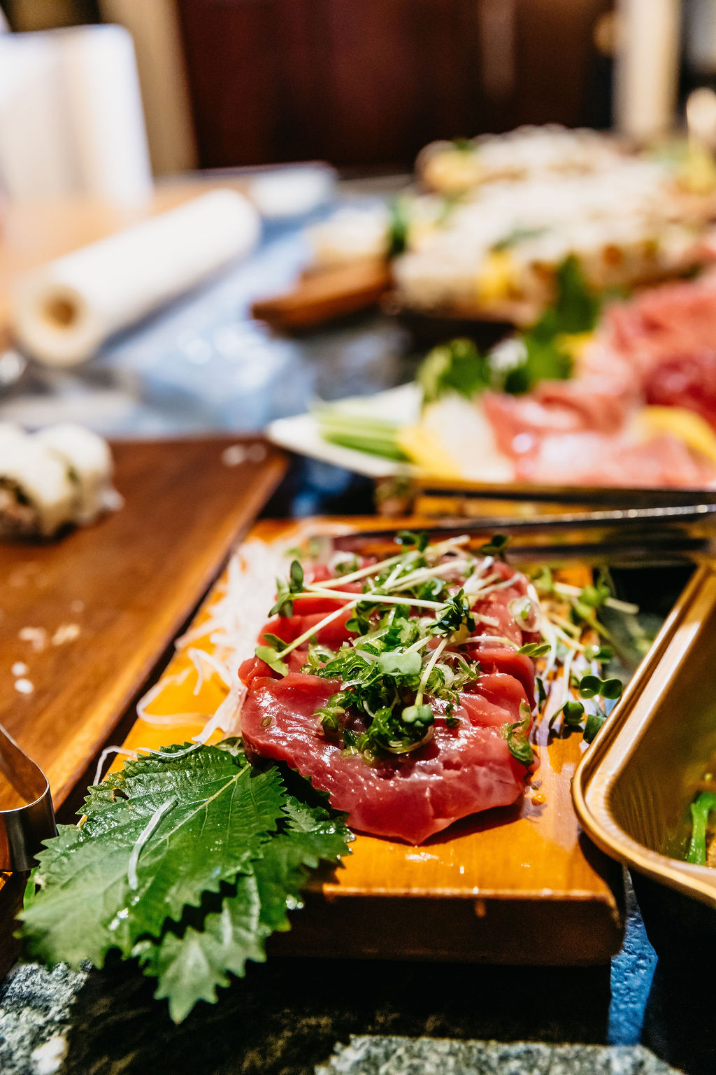 A sashimi roll dressed with fresh herbs